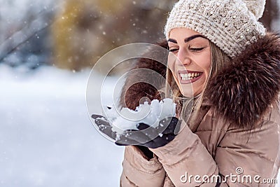 Blowing snow â€“Smiling girl blowing magic snow. Christmas magic Stock Photo